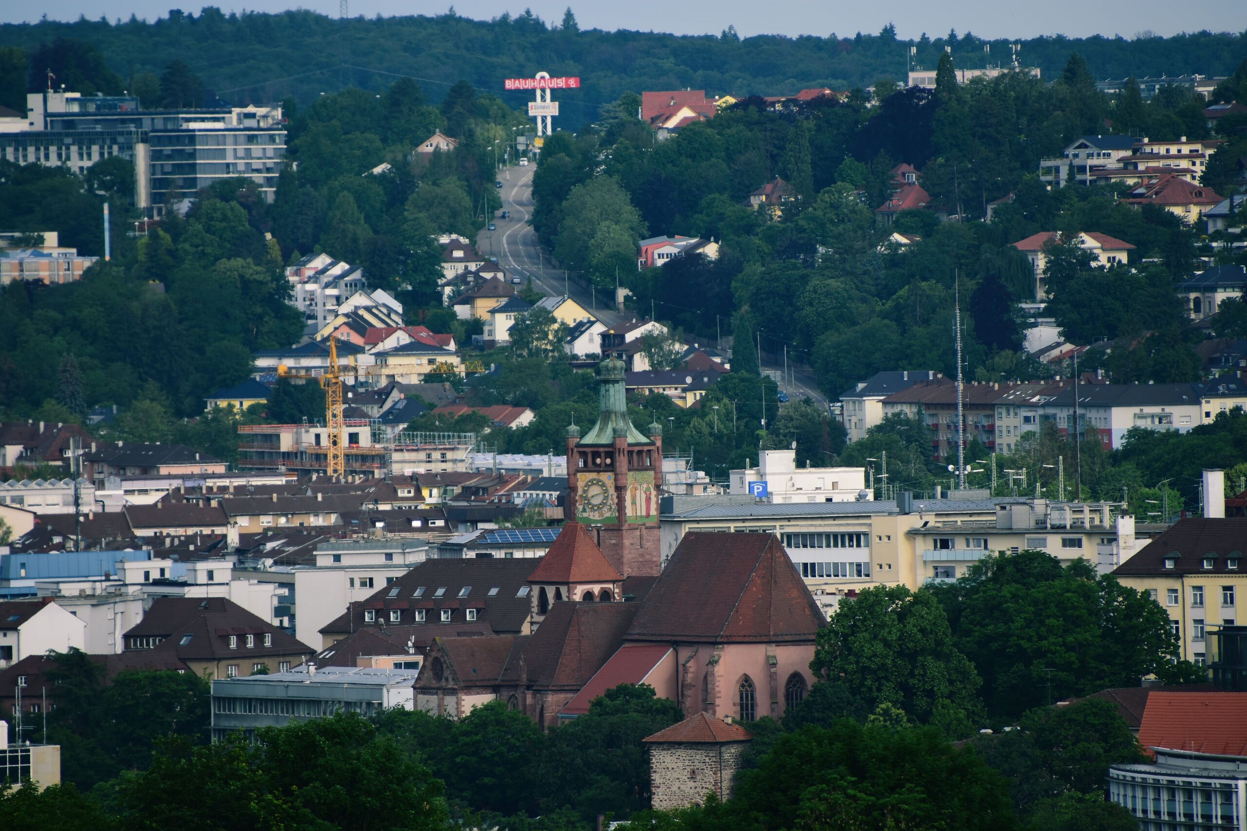 A picturesque view of Pforzheim's cityscape featuring a historic church surrounded by lush greenery.
