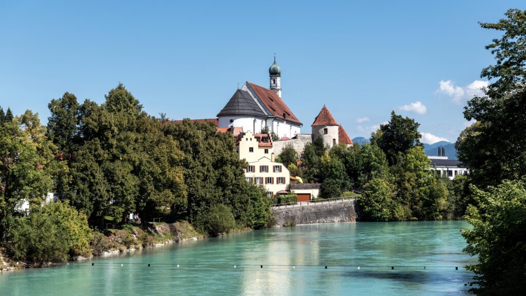 Picturesque town view in Füssen, Germany with a historic church and a river.